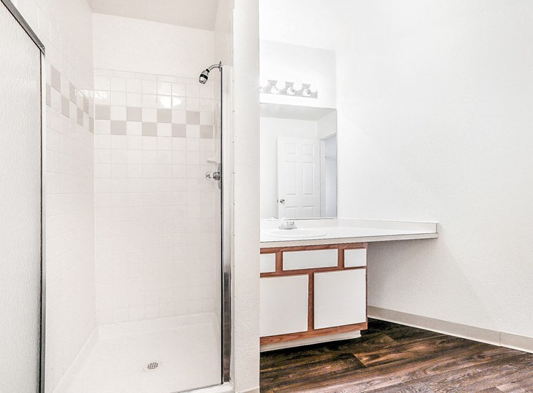 Bathroom with Walk in Shower and White Cabinets with Wood Accents